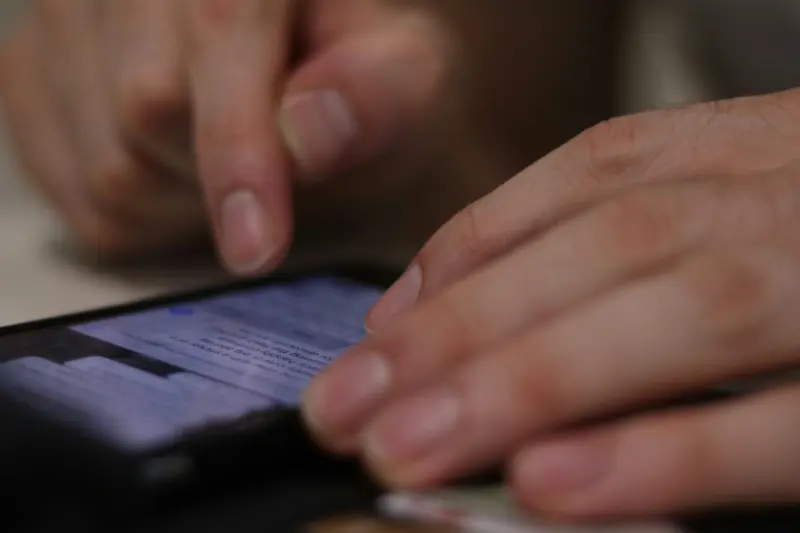 A man using a messaging app on a mobile phone