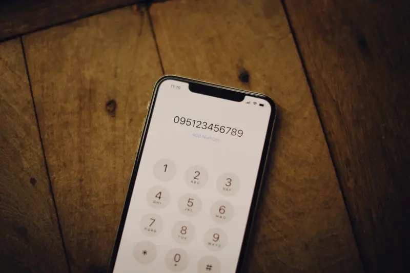 A modern phone placed onto a wooden table